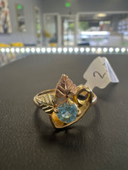10k blue stone ring with tricolored leaves