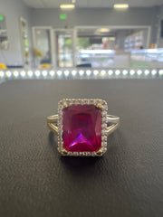 14k red stone ring with small white stones