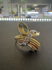 14k tricolored ring with small white stones