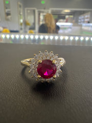 10k red stone ring with many white stones