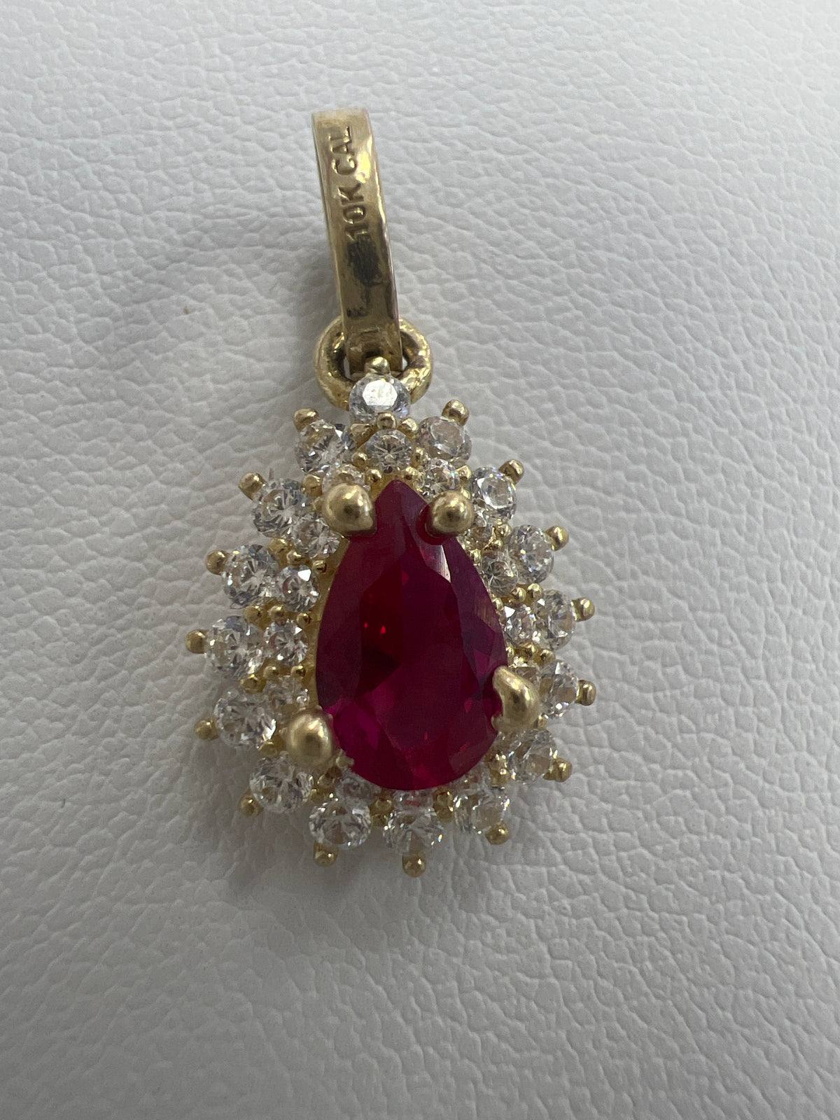 10k pear shape red stone pendant with white stones