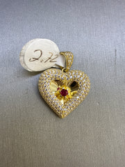 10k stone heart pendant with a single red stone in the middle