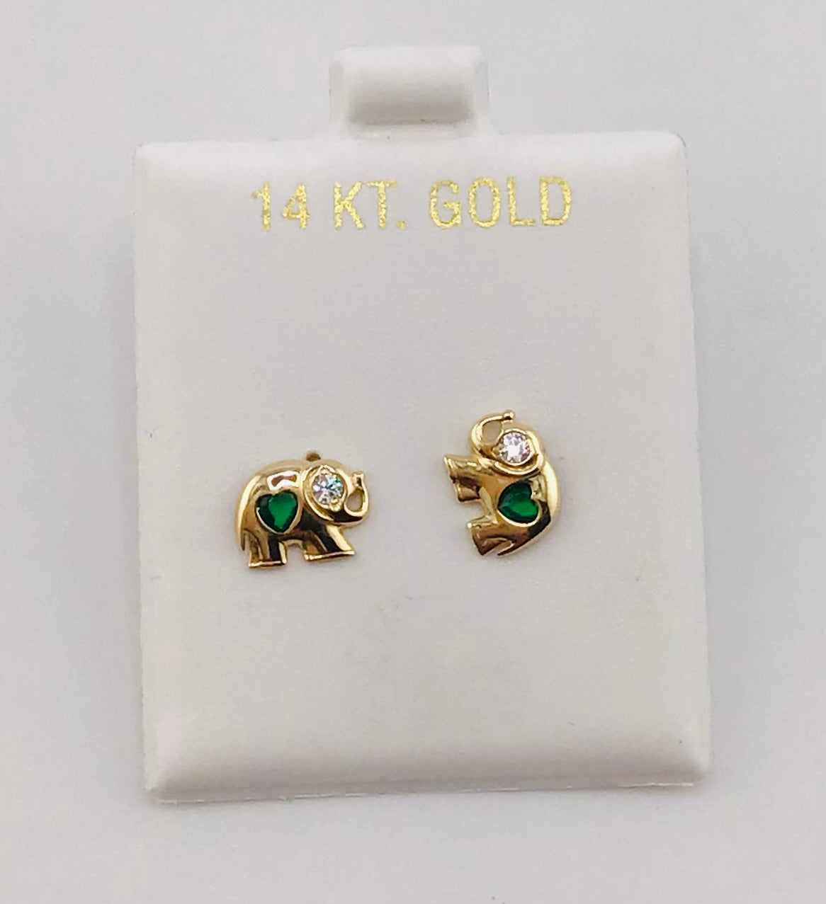 Baby earing elephant with green heart