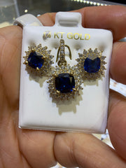 14k Earring and pendant in blue gems set in a floral-inspired sunburst halo design consisting of an inner ring of smaller round accents and an outer scalloped border of marquise-shaped