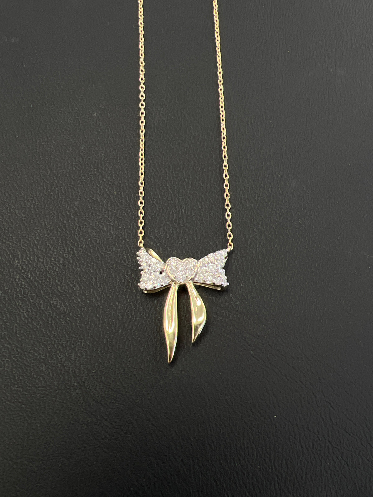 10kt gold bow necklace with .25ct diamond