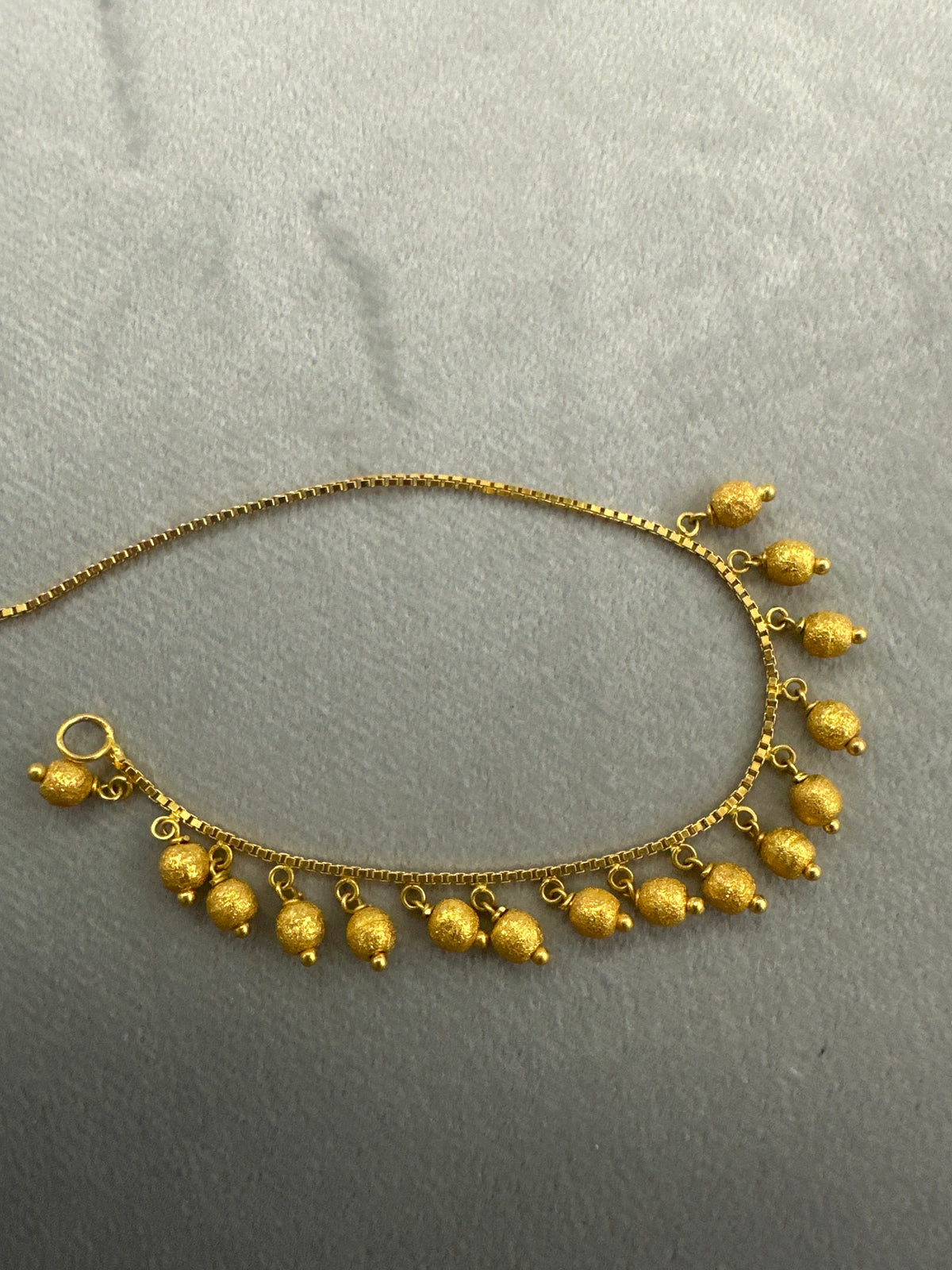 22k  gold charm bracelet