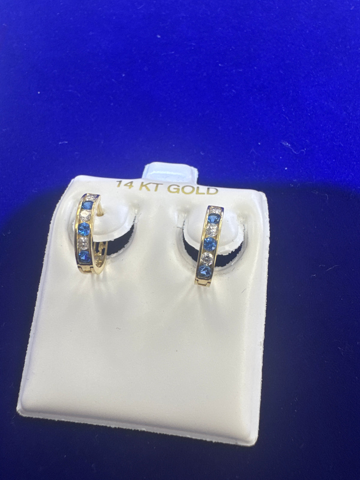 14k ladies earring Huggies with blue stones