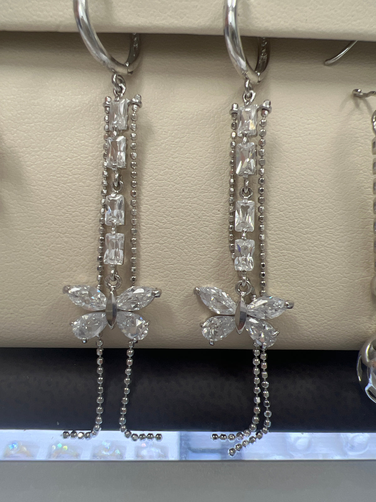 White gold long hanging earrings with butterfly and many stones