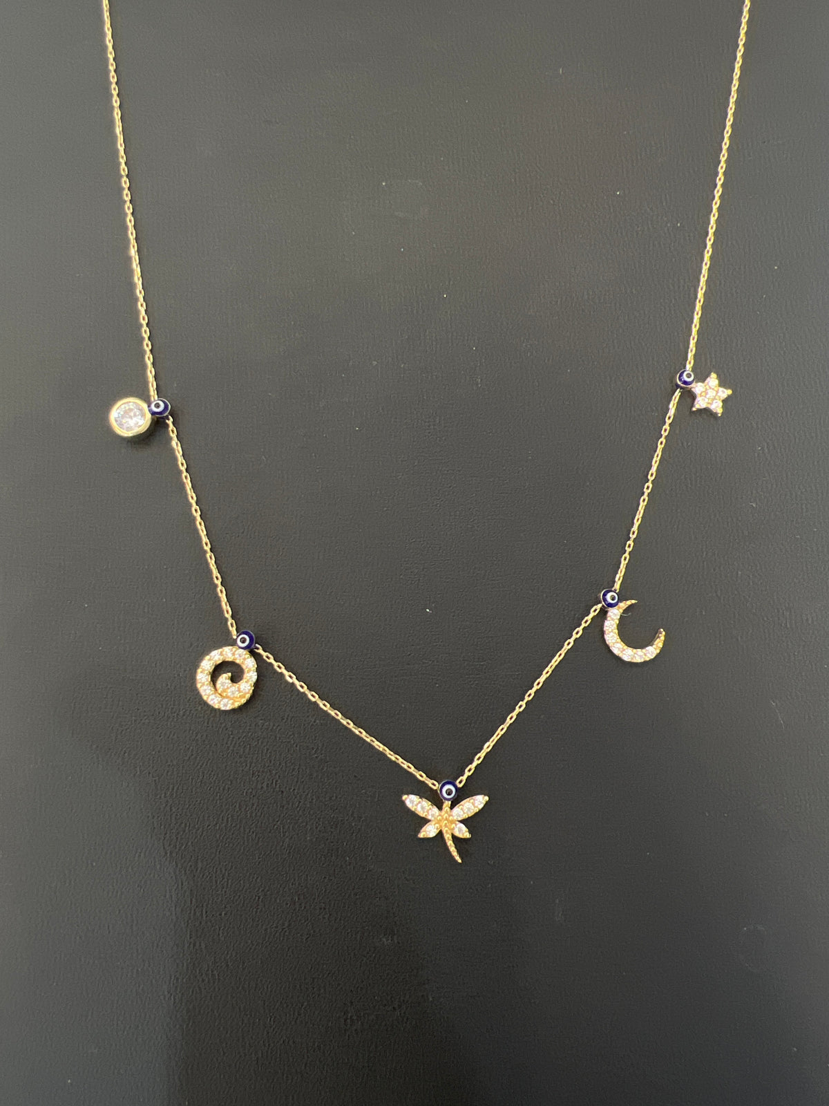 14k necklace with charms, stones, and evil eyes