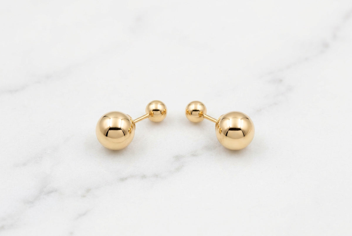 10k ladies earring with balls in front and back of different size