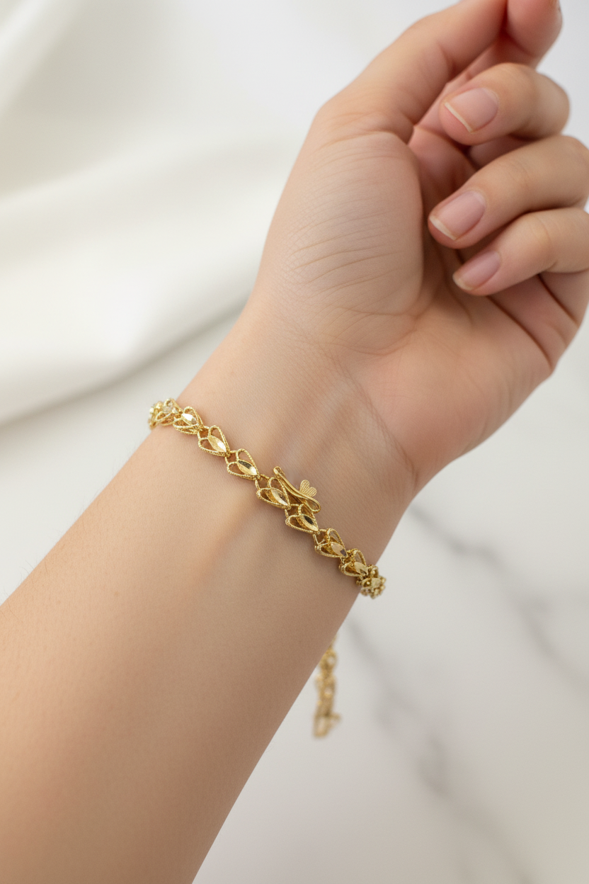14k heart bracelet solid gold with diamond cut hearts.