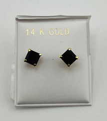 Baby earing small black stone